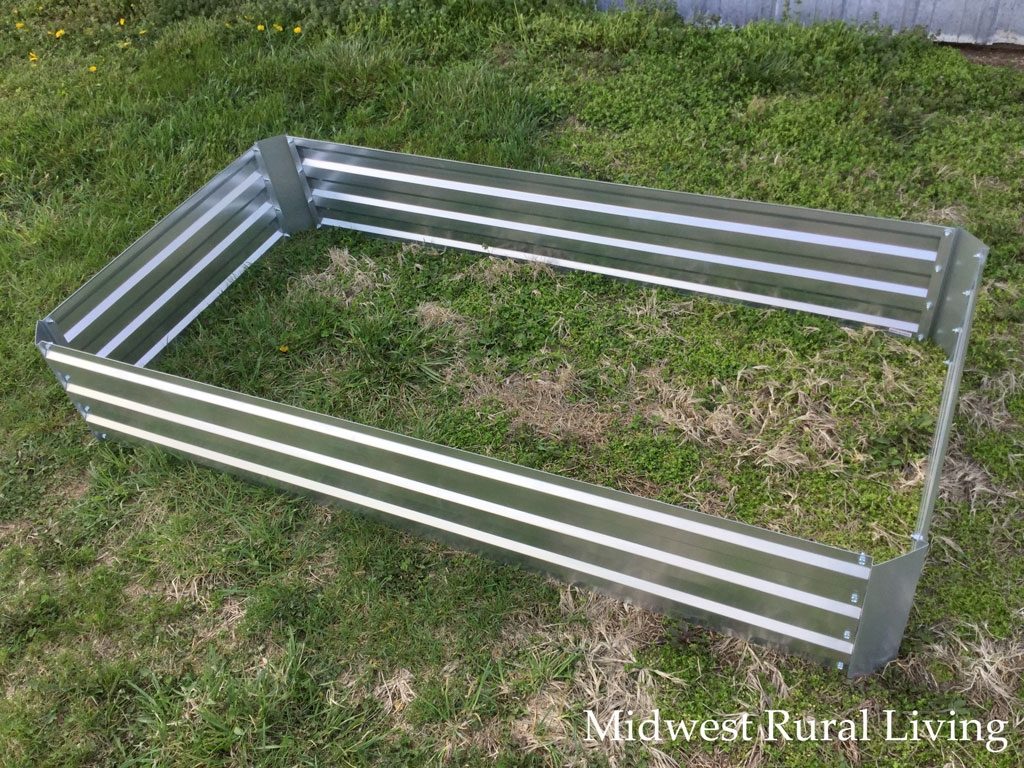 The fully assembled Castlecreek Large Galvanized Raised Bed Planter Box before it is placed in its final location.
